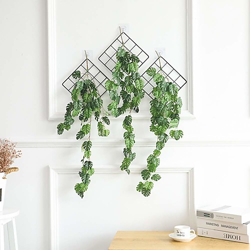

Висячие стены зеленые листья ротанга адаптируются к сельским украшениям дома